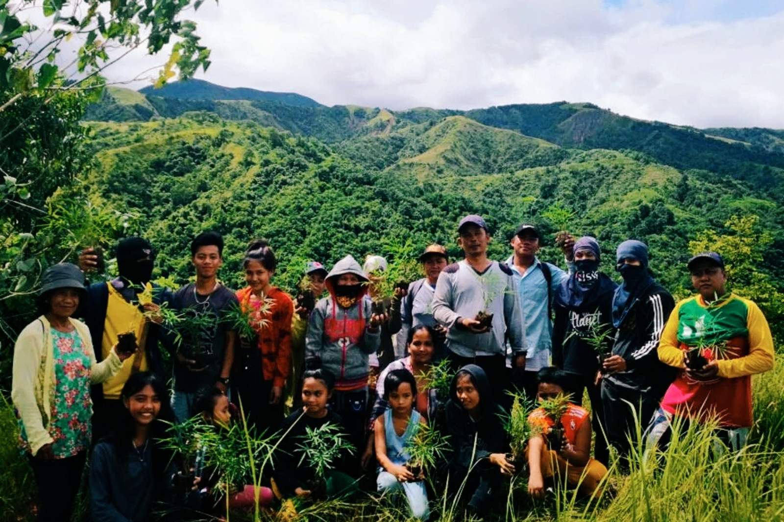 Bambuhay workers taken in the backdrop of mountainous area