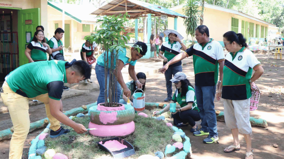 students and parents cleaning a school yard